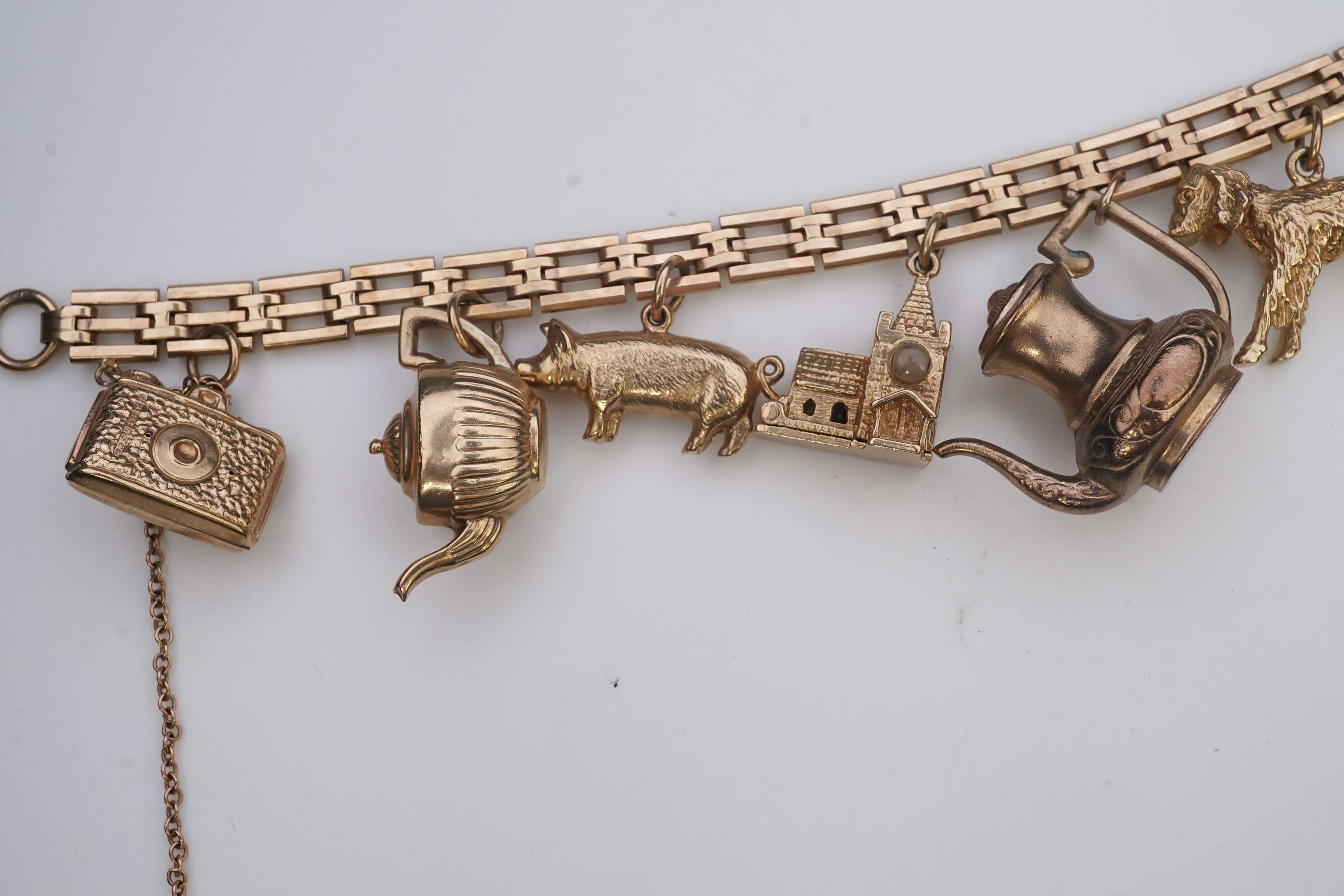 A charm bracelet, mid 20th century